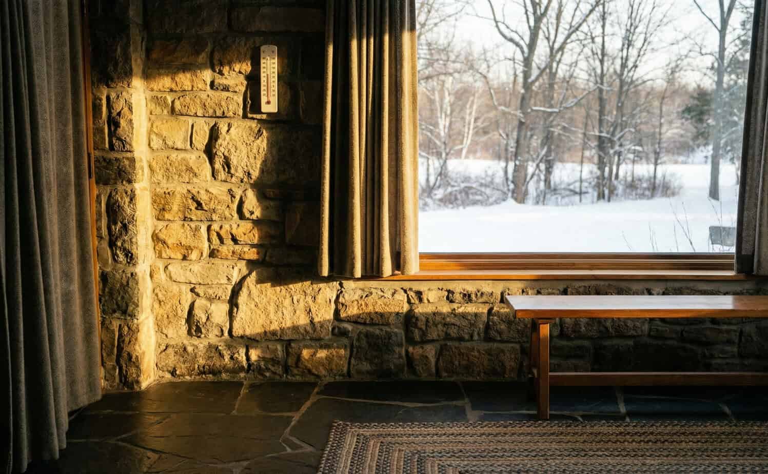 Passive heating system using sunlight and stone thermal mass to warm a home during winter