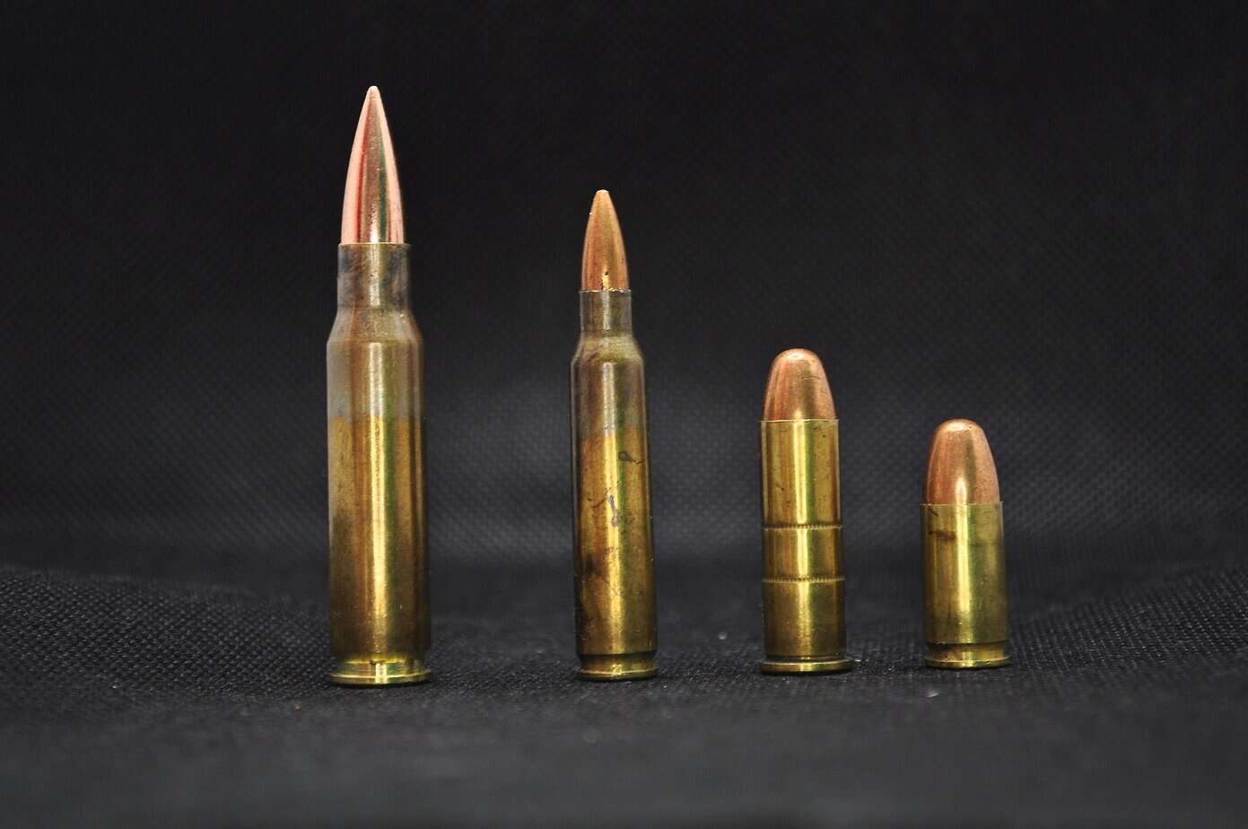 ammo caliber comparison for stockpiling including 5.56 rifle rounds and 9mm handgun cartridges
