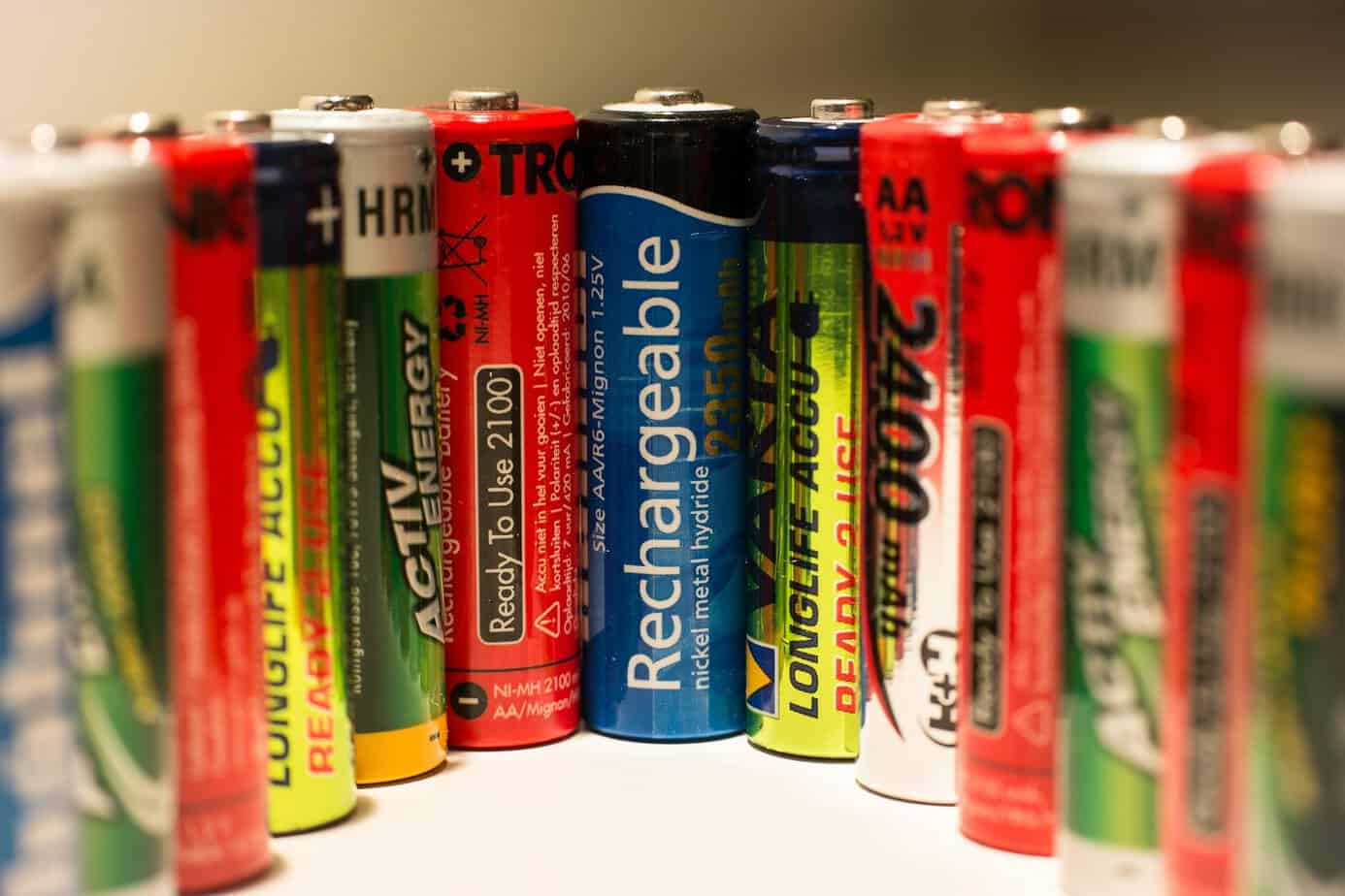 Row of rechargeable NiMH AA batteries standing upright, the type where batteries degrade faster in storage than in use