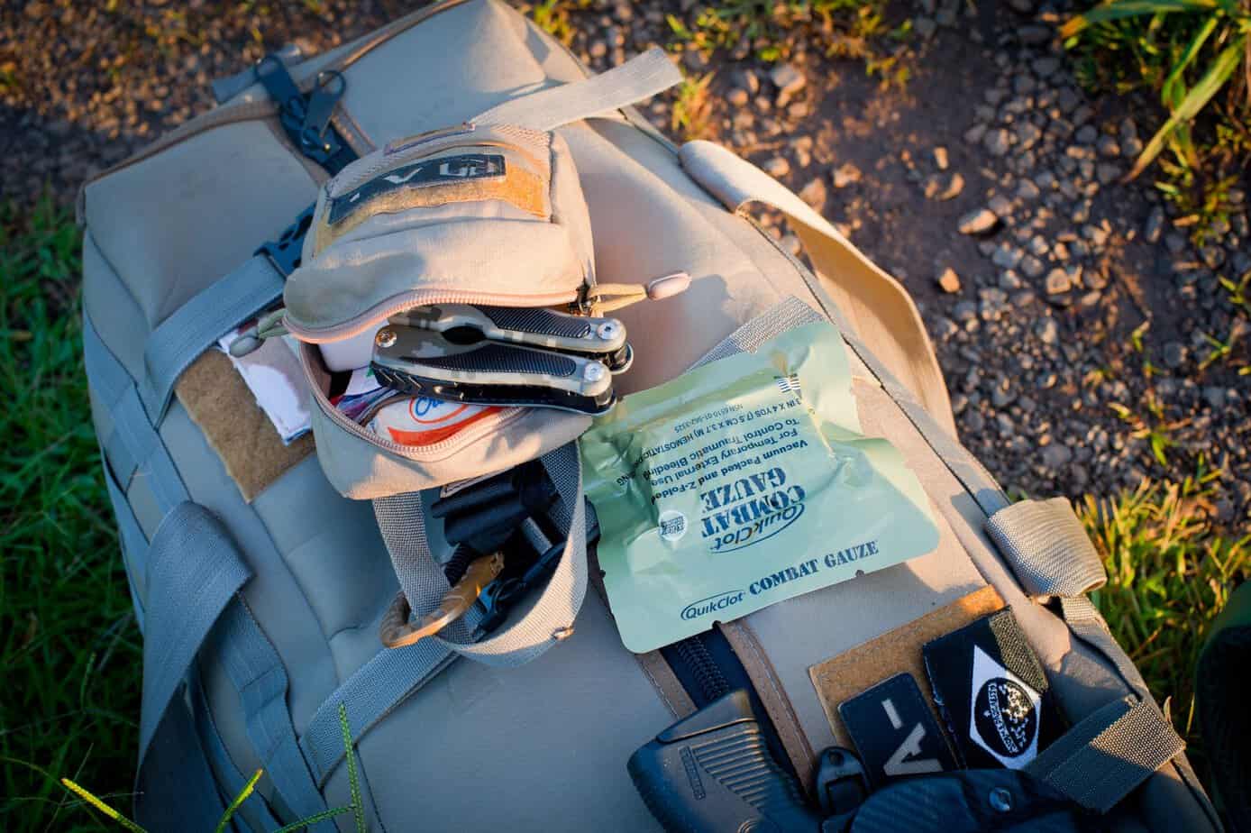 Seasonal get home bag with multitool, trauma shears and QuikClot combat gauze in an open front pocket